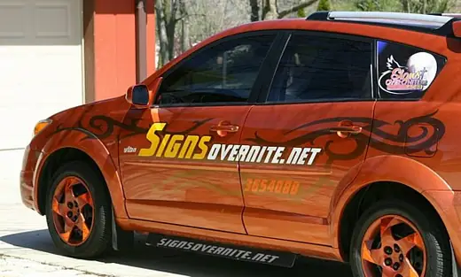 Orange car with black flame-style graphics