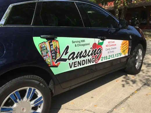 Black vehicle door with a colorful business graphic